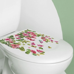Close-up of floral toilet sticker with pink flowers, green leaves and yellow butterfly