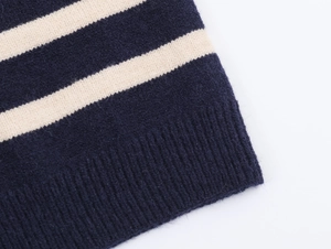 Close-up of navy and cream striped knit cardigan showing ribbed hem texture details