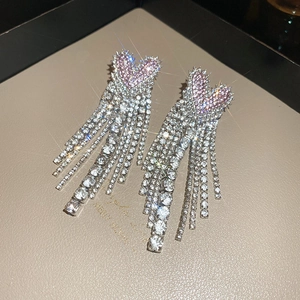 Detail of heart tassel earrings with pink crystals and long sparkling fringes