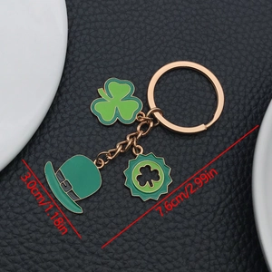 Detailed dimensions of St. Patrick's Day clover and hat keychain on black leather background