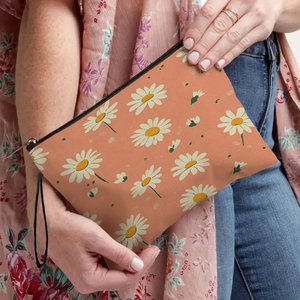 Trousse à maquillage florale avec motif de marguerites oranges, fermeture et sangle