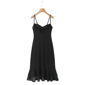 Detail of the back cutout and ruffled mesh hem on a sexy black chiffon maxi dress