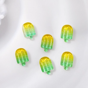Macro detail of 3D resin ice pop nail charms with gradient yellow to green texture