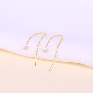 Detailed close-up of golden S925 sterling silver ear threads with brilliant cubic zirconia