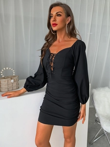 Slim fit black long sleeve mini dress with lace-up front and ruched body details