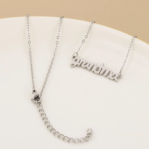 Macro shot of silver grandma pendant necklace with lobster clasp on a display tray