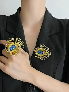 Detailed view of evil eye jewelry set with gold finish and rhinestone accents on model