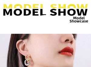 Close-up of model wearing two-tone interlocking oval earrings in gold and silver finish