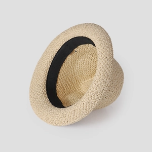 Detail view of the finely woven texture and black interior sweatband of the straw hat
