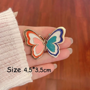 Detailed size view of a colorful butterfly enamel brooch with gold metal frame
