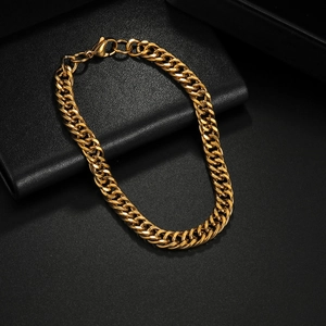Minimalist gold cuban link bracelet for men and women on a premium black textured surface
