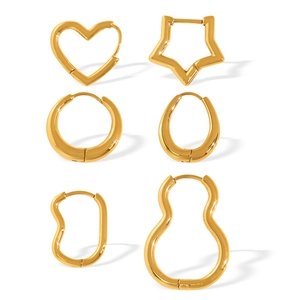 Set of six gold geometric hoop earrings including heart and star shapes in polished metal
