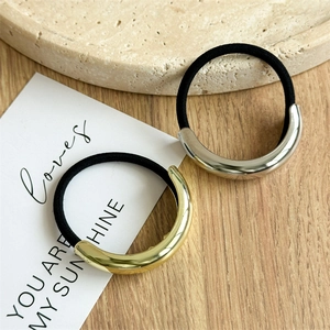 Minimalist alloy hair ties with gold and silver polished metal rings on stone base