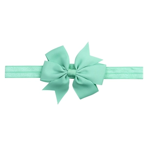 Detail of mint green grosgrain ribbon bow with high elastic headband for infants