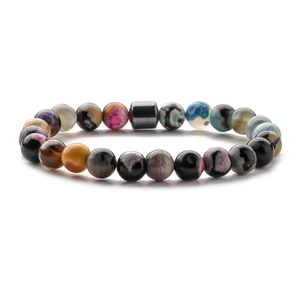 Detailed close-up of 8mm natural stone beads and magnetic hematite cylinder on mens bracelet