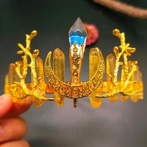 Detail of bohemian gold crown with natural yellow crystals and a crescent moon charm