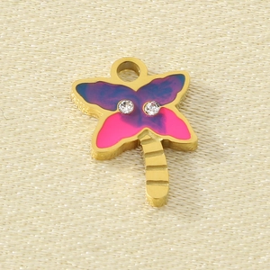Close-up of golden butterfly pendant with purple and pink enamel for DIY jewelry