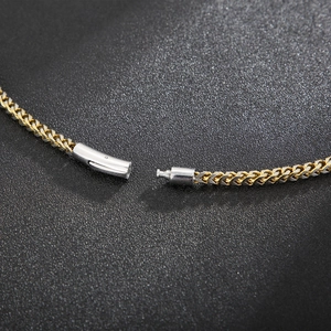 Detail of two-tone gold and silver dragon bone chain with secure clip-in buckle closure