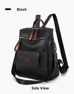 Detail of lychee-textured black PU leather backpack with contrasting brown zipper pulls