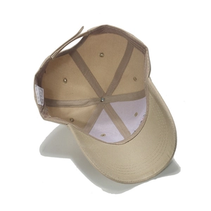 Detailed interior of khaki baseball cap showing 100% acrylic tag and 6-panel structure