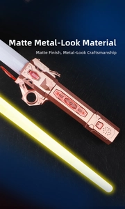 Detail of rose gold frosted metal handle and yellow glowing blade of the toy lightsaber