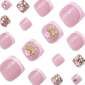 Pink press-on toenails with 3D gold butterflies, rhinestones, and French tip designs