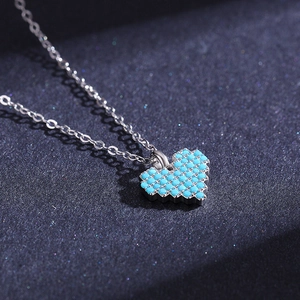 Elegant S925 silver necklace with pixel-style heart turquoise pendant on dark backdrop