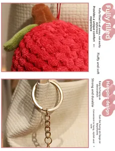 Close-up of plush litchi pendant with textured chenille fabric and golden keychain
