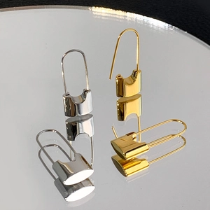 Minimalist U-shaped lock earrings in gold and silver finish with mirror reflection