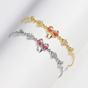 Detail showing gold and silver bow bracelets with pink pear-cut crystals and micro-pavé stones