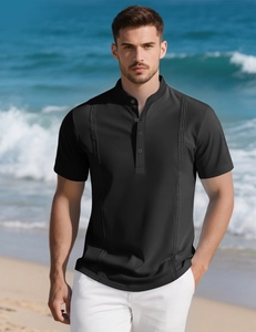 Close-up of black men's striped polo shirt with vertical embroidery on sunny beach