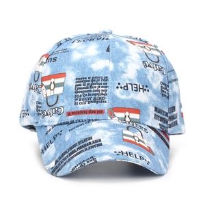 Detail of light blue denim baseball cap featuring vintage graffiti and newspaper collage print