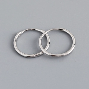 Macro view of polished S925 sterling silver hoop earrings with seamless clasp design