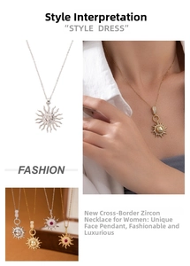 Detail view of sun face pendant necklace with red zircon and radiant relief design