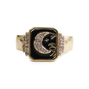 Golden moon star ring with black enamel and zircon inlay on a white background