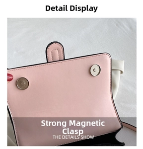 Detail of pink leather handbag showing dual magnetic closure and fine black edge finishing