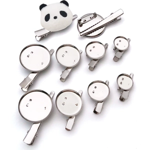 Close-up of metal alligator clips with round bases for DIY brooch and hair accessory crafting