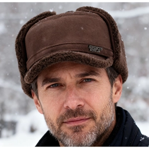 Detail of warm brown trapper hat featuring faux fur lining and NYBJA sports logo