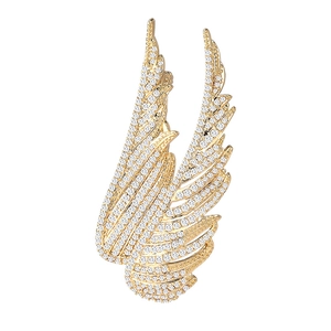 Elegant gold-plated wing brooch featuring shimmering cubic zirconia on white background