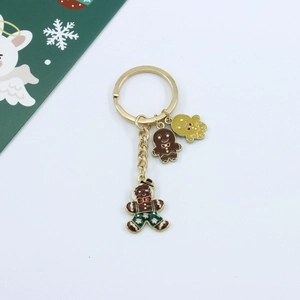 Detailed view of gingerbread man metal keychain with golden ring and colorful charms
