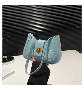 Close-up of light blue glitter crescent bag with golden hardware and PU leather strap