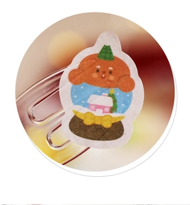 Macro detail of a cute Christmas bear snow globe sticker with festive holiday decorations