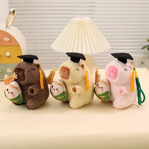 Capybara plush toy with graduation cap and lucky dumpling in three soft pastel colors