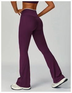 Detail view of high-waisted dark purple flared yoga pants with professional fit and texture