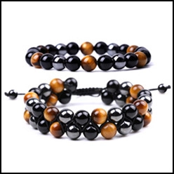 Detail view of handcrafted beaded bracelets with tiger eye, obsidian, and hematite beads