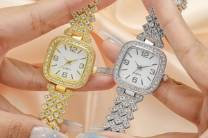 Close-up of gold and silver quartz watches with rhinestone bezel and metal chain strap