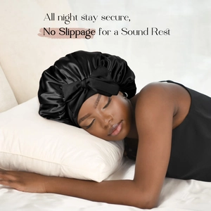 Close-up of black satin sleep bonnet featuring a large bow and elastic non-slip edge