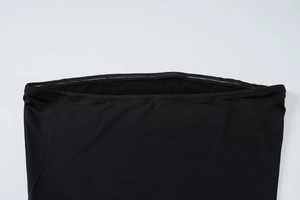 Close-up detail of black strapless tube top featuring elastic fabric and reinforced stitching