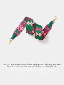 Detail of green checkerboard woven strap with gold buckle and leather ends for bags