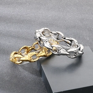 Detail view of punk rock crab claw link bracelets in vintage gold and silver stainless steel
